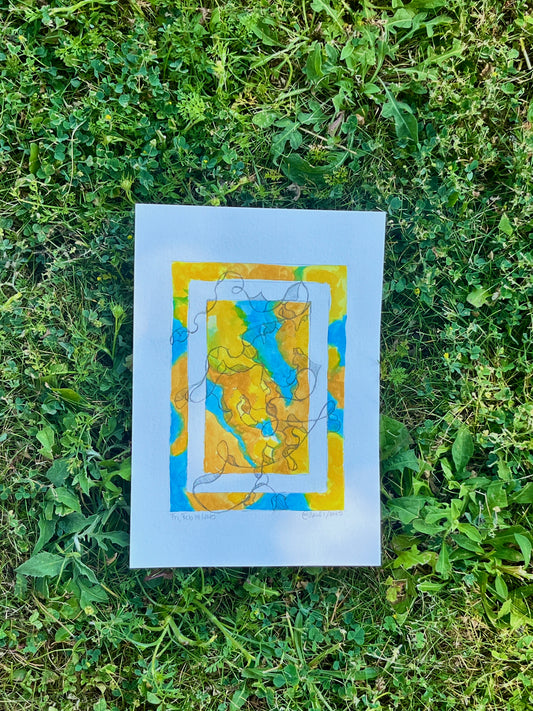 Bright, colourful abstract painting on paper laying in the grass