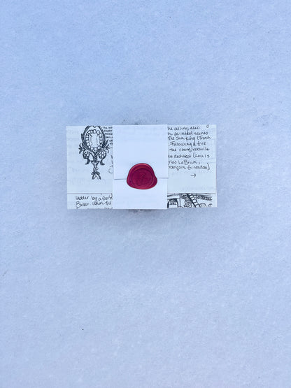 Illustrated letter sealed with a red wax seal. Mni art print hidden inside